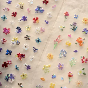 Macro shot of 3D floral nail stickers with laser pearlescent finish and tulip patterns