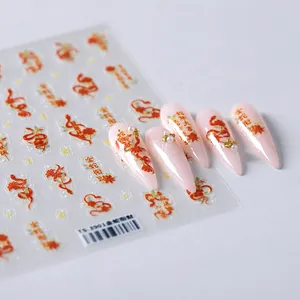 Golden snake and festive Chinese New Year nail decals on matte pink false nails
