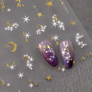 Celestial matte nail stickers with gold foil stars and moons on purple gradient nails