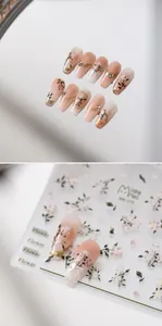 Detailed view of hand-painted gradient fake nails with white flowers and rhinestones