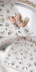 Detailed view of MN-379 3D nail art stickers with pink floral designs and golden lines
