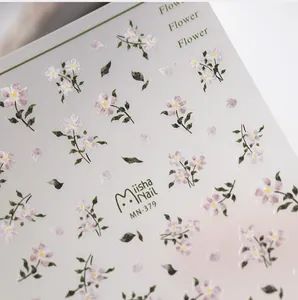 Macro shot of MN-379 nail stickers with fine pink floral patterns and green leaves