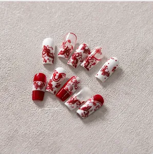 Detailed view of red and white Chinese dragon style nail stickers with calligraphy motifs