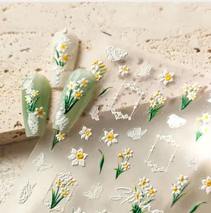 Close-up of 5D embossed floral nail stickers with white daisies and butterfly details