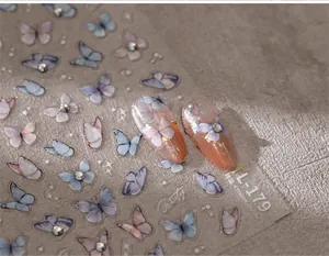 Macro detail of TL-179 butterfly nail stickers with 3D texture and rhinestone accents