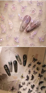 Macro detail of 3D embossed nail stickers featuring gold foil butterflies and ancient motifs