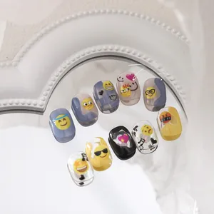 Detailed view of matte Emoji nail stickers featuring smiley faces and yellow icons