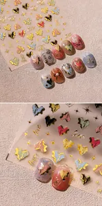 Macro detail of irregular golden heart nail stickers and 3D metallic love decals