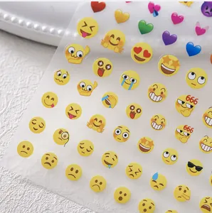 Detailed view of TK-002 nail art stickers featuring cute emoji faces and colorful hearts