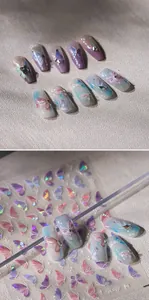 Detail of holographic gold butterfly nail art stickers with iridescent purple gradients
