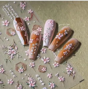 Macro detail of 3D embossed peach blossom nail stickers with Chinese window patterns