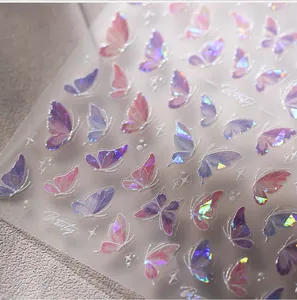 Macro view of holographic butterfly nail stickers with shimmering pink and purple reflection