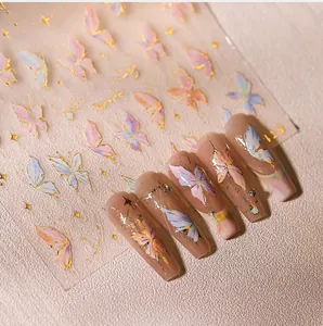 Macro detail of colorful butterfly nail stickers with gold accents and star elements