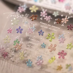 Macro detail of 3D embossed colorful floral nail stickers with a glossy jelly finish