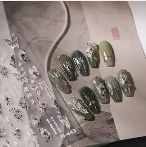 Macro view of butterfly and floral 3D embossed nail stickers with M-443 aurora finish