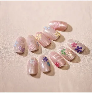 Macro shot of 3D floral nail art with cat eye effect and embossed pink jelly finish