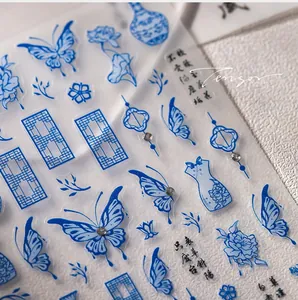 Macro detail of blue porcelain nail art stickers with butterfly and floral patterns