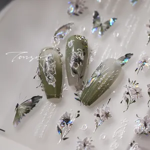 Macro detail of 3D embossed floral and butterfly nail stickers with pearlescent finish