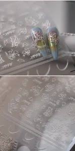 Detailed view of 3D embossed floral nail stickers featuring lilies and butterfly motifs