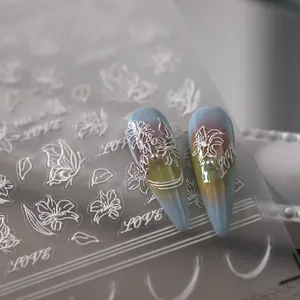 3D embossed white floral and butterfly nail stickers with pearls on gradient background