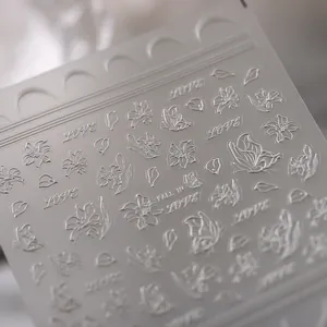 Elegant 5D relief nail stickers featuring white lily flowers and butterflies for DIY manicure