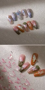 Detail of holographic gold butterfly nail stickers with purple and green pearl finish