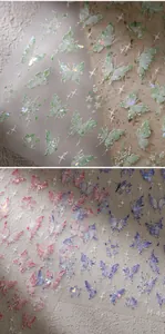 Close-up of holographic butterfly nail art stickers with glitter laser effects and stars