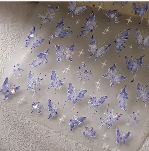 Macro shot of M-45 laser holographic purple butterfly nail art stickers with glitter
