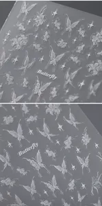 Detailed macro view of 3D embossed white butterfly and rose floral nail art stickers