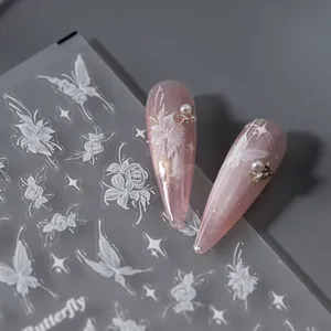 5D embossed white butterfly nail stickers with floral patterns on pink manicure