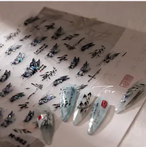Detailed view of aurora laser butterfly and ink bamboo nail art stickers on a classic background