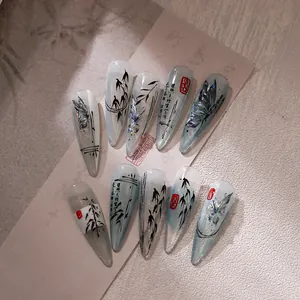 Ink butterfly almond press-on nails with bamboo motifs and sheer blue shimmering base