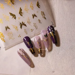 Macro detail of M-266 nail art stickers featuring golden butterfly and calligraphy motifs