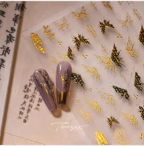 Macro view of butterfly nail art stickers with gold foil and fine calligraphy on lilac nails