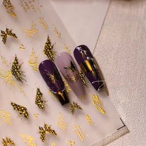 Detail showing 3D butterfly nail art stickers in gold and black on manicure tips