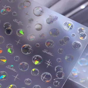 Macro view of holographic 3D nail art stickers with bubble and starburst patterns