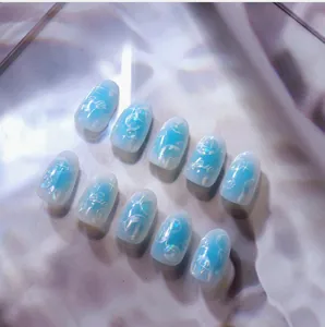 Macro shot of 3D gradient light blue nail art stickers with bubble and star patterns