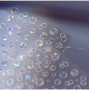 Detailed holographic nail art stickers featuring bubble and star designs with laser finish
