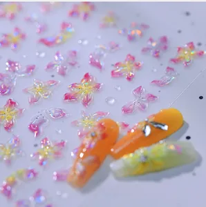 Close-up of 5D floral nail stickers with aurora gradient and metallic shimmer texture