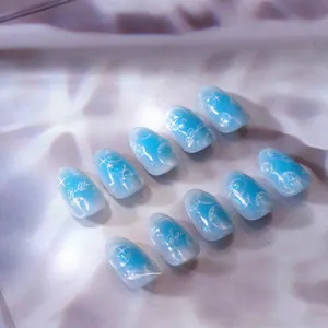 Detailed view of ice blue bubble press-on nails with white starry patterns and shell luster