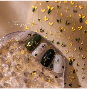 Detailed view of gold bohemian nail stickers with butterfly moon and star patterns