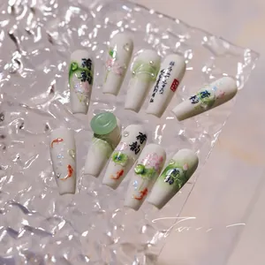 Detailed macro view of 3D lotus and koi fish nail art stickers with elegant calligraphy
