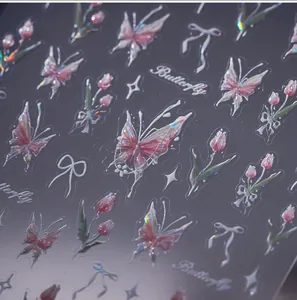 Macro detail of laser holographic nail stickers featuring pink tulips and butterflies