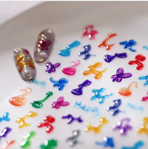 Macro detail of 3D embossed colorful balloon nail art stickers with Happy text design