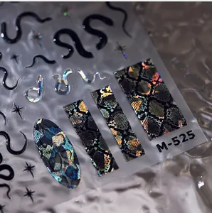 Détail macro des stickers ongles 3D M-525 avec motifs serpent laser et étoiles dorées