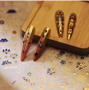 Detailed view of M-606 vintage gold foil nail stickers with floral and butterfly motifs