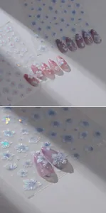Close-up of 3D embossed floral nail stickers with pearlescent finish and rhinestones
