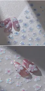 Macro shot of 5D embossed cherry blossom nail stickers with aurora holographic finish