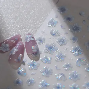 Holographic blue floral nail stickers with iridescent petals and sparkling star elements