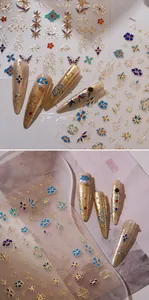 Detailed view of M-611 gold embossed nail art stickers with blue and red floral patterns